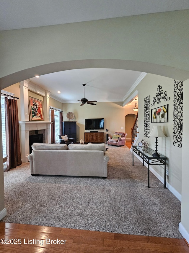 905 Fossil Creek Cir, Louisville, KY 40245 - living area featuring arched walkways, ornamental molding, baseboards, a ceiling fan, and a fireplace