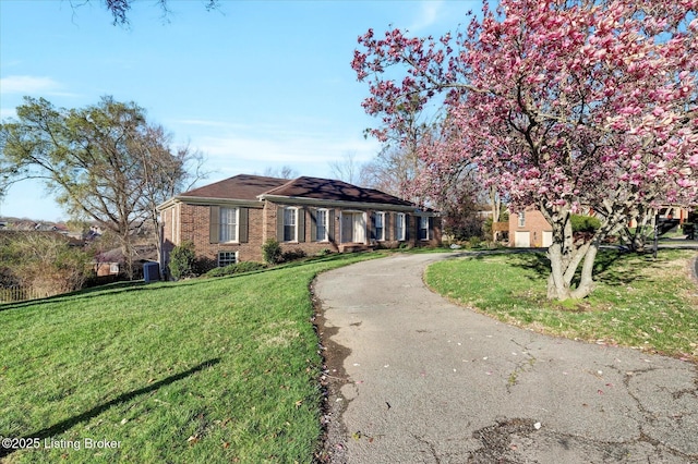 7208 Iron Gate Ct, Louisville, KY 40241 - single story home with curved driveway, a front yard, and brick siding