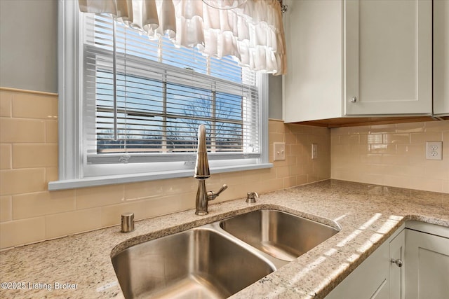 7208 Iron Gate Ct, Louisville, KY 40241 - kitchen view of a sink, decorative backsplash, white cabinets, and light stone countertops