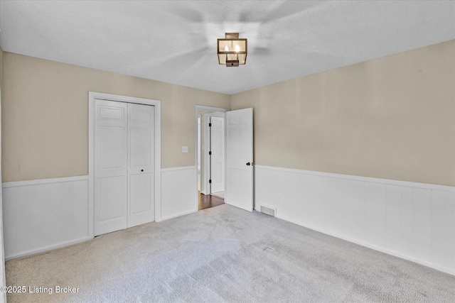 7208 Iron Gate Ct, Louisville, KY 40241 - unfurnished bedroom featuring carpet, a wainscoted wall, and a closet