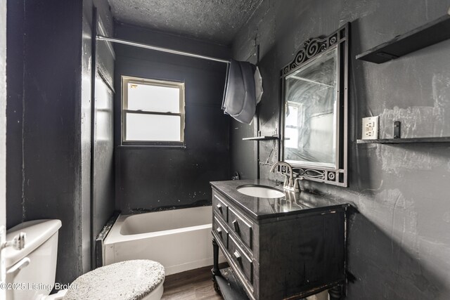1724 W Ormsby Ave, Louisville, KY 40210 - full bath with toilet, wood finished floors, vanity, shower / bathtub combination, and a textured ceiling