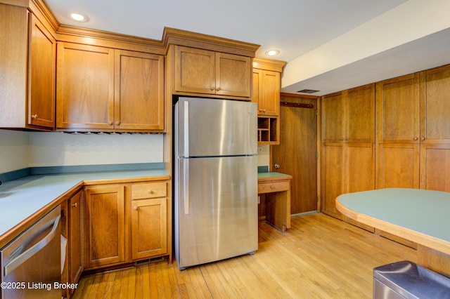 9113 Darley Dr, Louisville, KY 40241 - kitchen featuring stainless steel appliances, brown cabinets, light wood-type flooring, light countertops, and recessed lighting