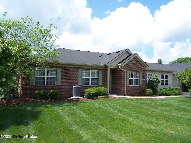 1411 Amberlin Ln, Louisville, KY 40245 - ranch-style house with brick siding, cooling unit, and a front yard
