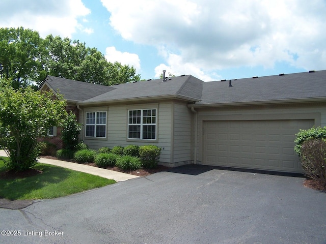 1411 Amberlin Ln, Louisville, KY 40245 - single story home with asphalt driveway and an attached garage