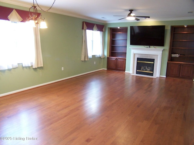 1411 Amberlin Ln, Louisville, KY 40245 - unfurnished living room with wood finished floors, a ceiling fan, a tiled fireplace, ornamental molding, and built in shelves