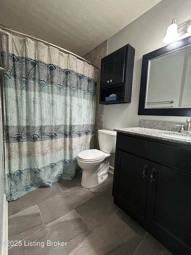 8411 Ambrosse Ln Unit 104, Louisville, KY 40299 - full bath featuring a textured ceiling, toilet, vanity, tile patterned flooring, and curtained shower