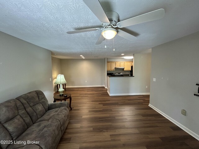 8411 Ambrosse Ln Unit 104, Louisville, KY 40299 - living room with dark wood-style floors, baseboards, a ceiling fan, and a textured ceiling
