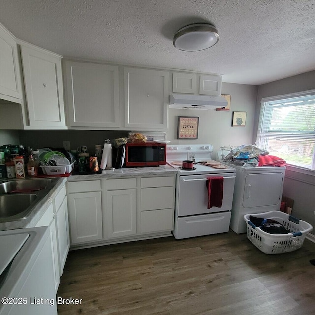 kitchen featuring white range with electric cooktop, white cabinetry, stove, washing machine and dryer, and a textured ceiling