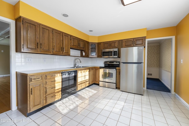 12100 Edenwood Dr, Louisville, KY 40243 - kitchen with appliances with stainless steel finishes, a sink, light countertops, baseboards, and a wainscoted wall