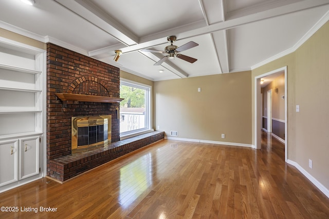 12100 Edenwood Dr, Louisville, KY 40243 - unfurnished living room featuring wood finished floors, baseboards, a ceiling fan, a brick fireplace, and beam ceiling