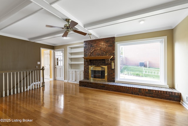 12100 Edenwood Dr, Louisville, KY 40243 - unfurnished living room featuring beamed ceiling, hardwood / wood-style floors, a ceiling fan, a brick fireplace, and built in features