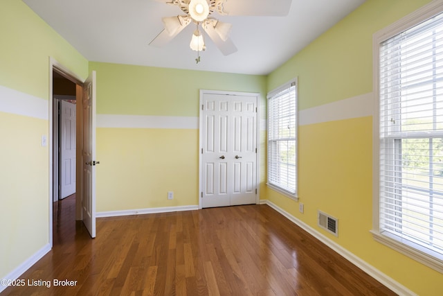 12100 Edenwood Dr, Louisville, KY 40243 - unfurnished bedroom with wood finished floors, baseboards, a closet, and a ceiling fan