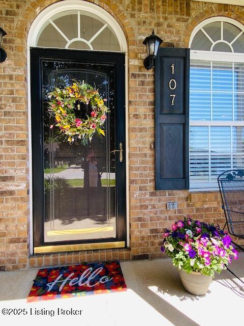view of exterior entry with brick siding