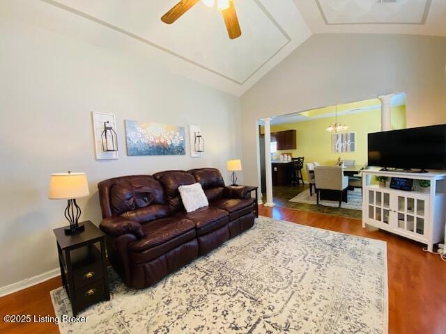 living area featuring vaulted ceiling, ceiling fan, wood finished floors, and baseboards