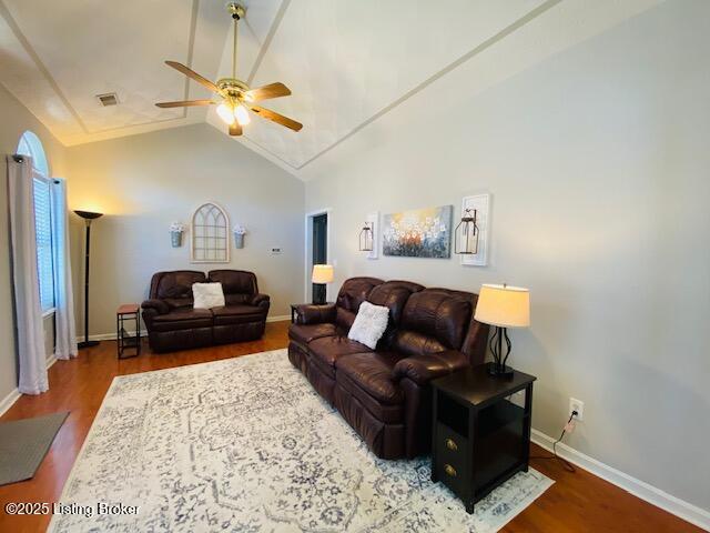 living room featuring a ceiling fan, wood finished floors, vaulted ceiling, and baseboards