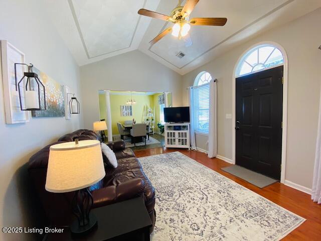 living area featuring attic access, a ceiling fan, wood finished floors, and lofted ceiling