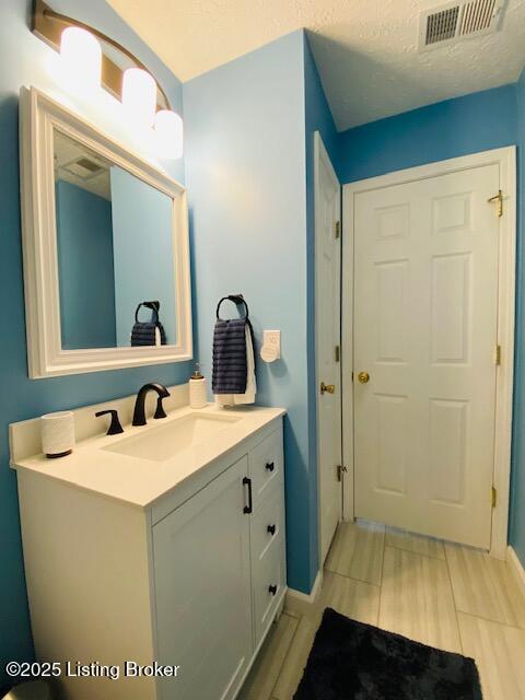 bathroom featuring baseboards and vanity