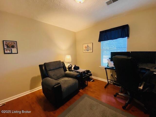office space featuring baseboards and wood finished floors