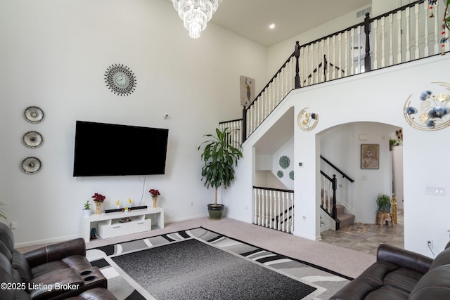 15803 Stonehouse Ct, Louisville, KY 40245 - carpeted living area featuring a towering ceiling, stairway, and arched walkways