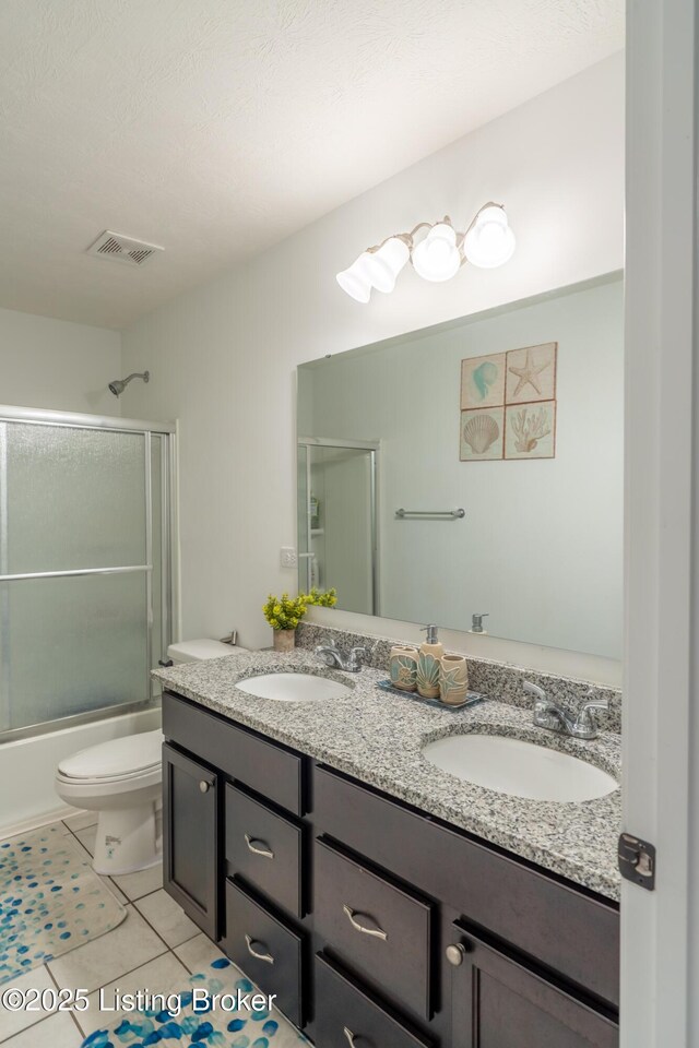 15803 Stonehouse Ct, Louisville, KY 40245 - full bath featuring double vanity, tile patterned flooring, and bath / shower combo with glass door