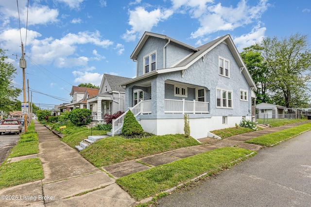 835 Sylvia St, Louisville, KY 40217 - view of front facade featuring a porch and stucco siding