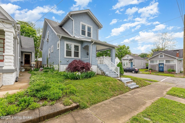 835 Sylvia St, Louisville, KY 40217 - view of front facade with a porch, a residential view, and stucco siding