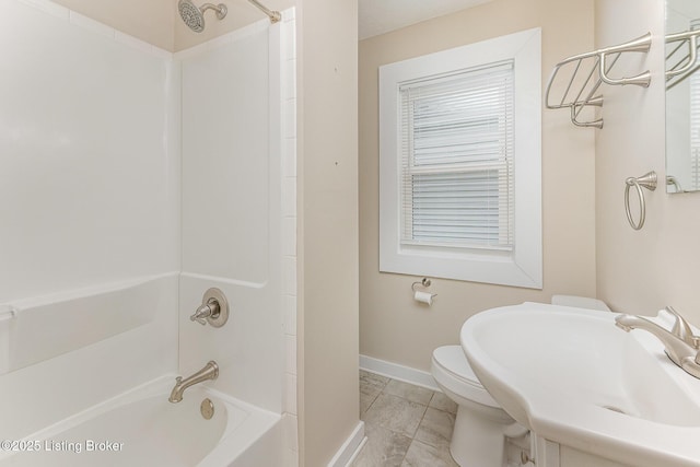835 Sylvia St, Louisville, KY 40217 - full bathroom with toilet, a sink, baseboards, and shower / bath combination