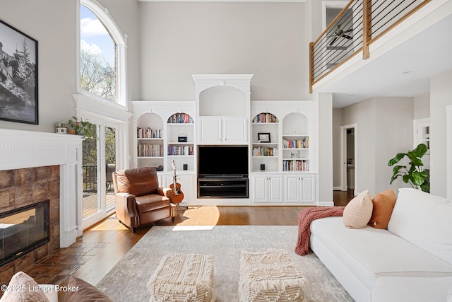 7006 Breakwater Pl, Prospect, KY 40059 - living room featuring a towering ceiling, wood finished floors, and a tiled fireplace