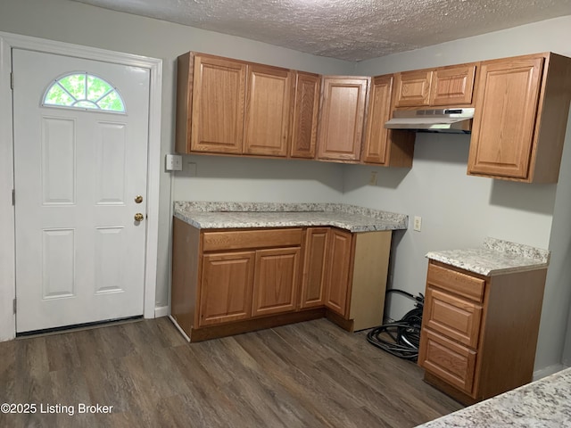 2532 Garland Ave, Louisville, KY 40211 - kitchen featuring under cabinet range hood, dark wood finished floors, a textured ceiling, and light countertops