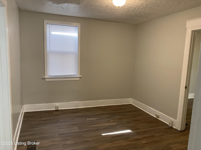 2532 Garland Ave, Louisville, KY 40211 - spare room featuring dark wood-style floors, a textured ceiling, and baseboards