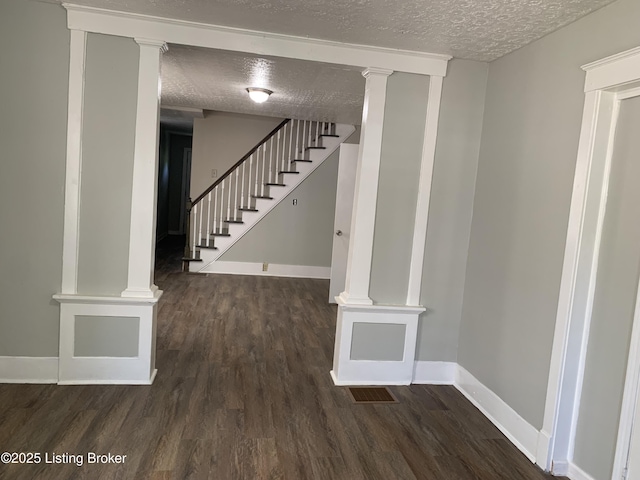 2532 Garland Ave, Louisville, KY 40211 - stairway with a textured ceiling, wood finished floors, baseboards, and ornate columns