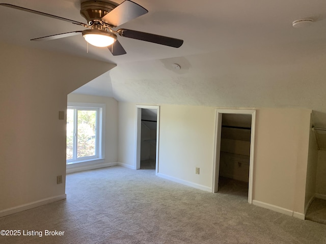 2532 Garland Ave, Louisville, KY 40211 - unfurnished bedroom featuring carpet, lofted ceiling, baseboards, a walk in closet, and a ceiling fan