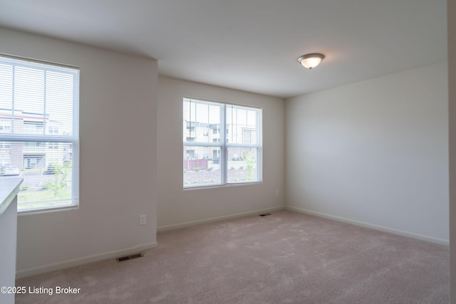 7618 Fair Ln, Louisville, KY 40291 - spare room featuring plenty of natural light, light colored carpet, and baseboards