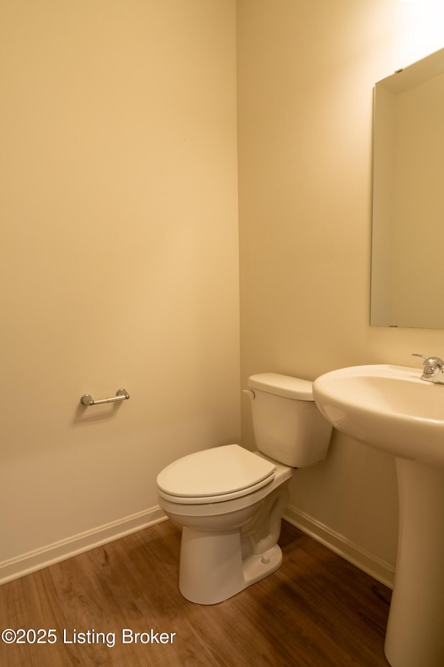 7618 Fair Ln, Louisville, KY 40291 - half bath featuring baseboards, wood finished floors, toilet, and a sink