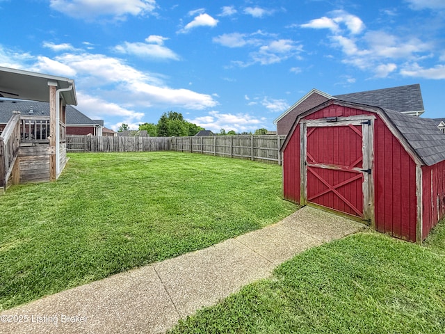 view of yard featuring a storage shed and an outbuilding