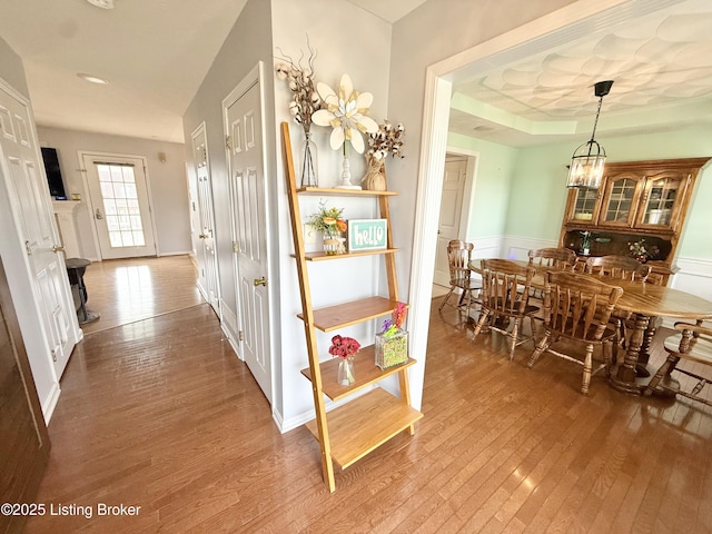 corridor featuring hardwood / wood-style floors and a wainscoted wall