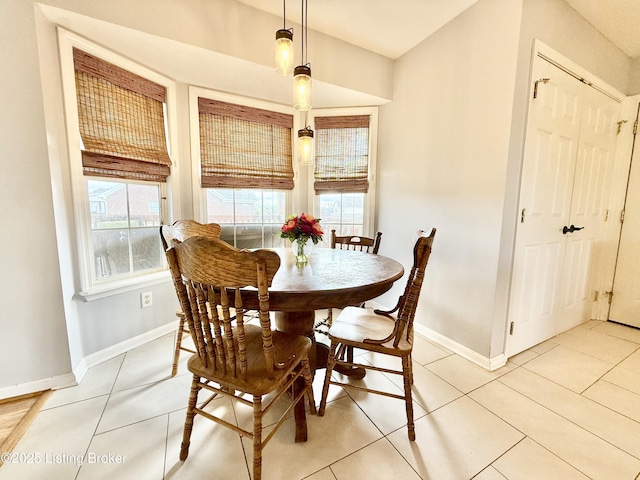 dining area with plenty of natural light, baseboards, and light tile patterned floors