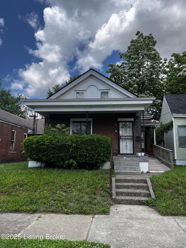 view of front of home featuring a porch and brick siding