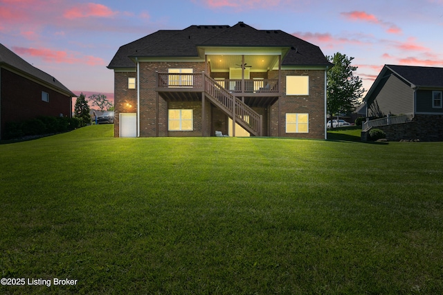 3403 Heather Wood Dr, La Grange, KY 40031 - back of property at dusk with brick siding, ceiling fan, a lawn, and stairs