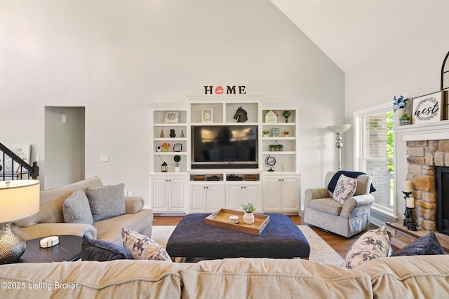 3403 Heather Wood Dr, La Grange, KY 40031 - living room featuring high vaulted ceiling, light wood-type flooring, and a stone fireplace