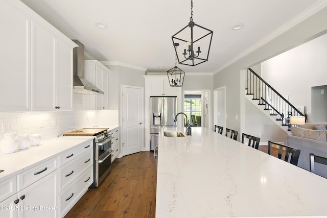 3403 Heather Wood Dr, La Grange, KY 40031 - kitchen featuring appliances with stainless steel finishes, wall chimney exhaust hood, a chandelier, a sink, and white cabinets