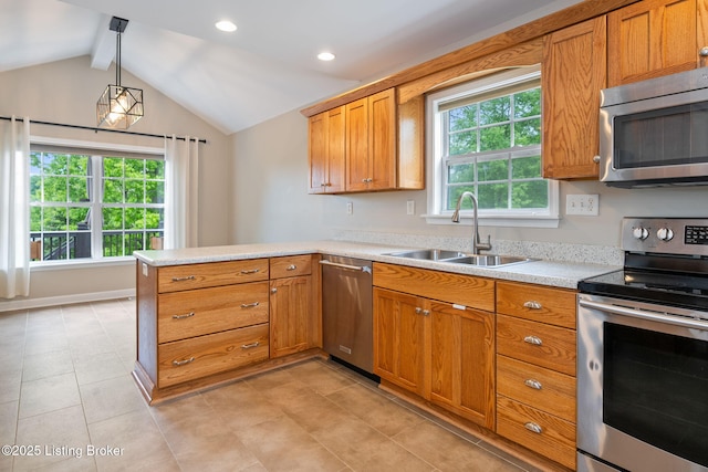1613 E Crystal Dr, La Grange, KY 40031 - kitchen with stainless steel appliances, a sink, a peninsula, light countertops, and brown cabinets