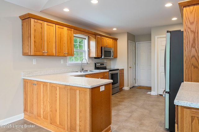 1613 E Crystal Dr, La Grange, KY 40031 - kitchen featuring stainless steel appliances, a sink, a peninsula, recessed lighting, and brown cabinets