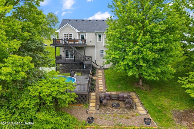 1613 E Crystal Dr, La Grange, KY 40031 - rear view of property featuring a deck, a fire pit, stairs, a shingled roof, and fence