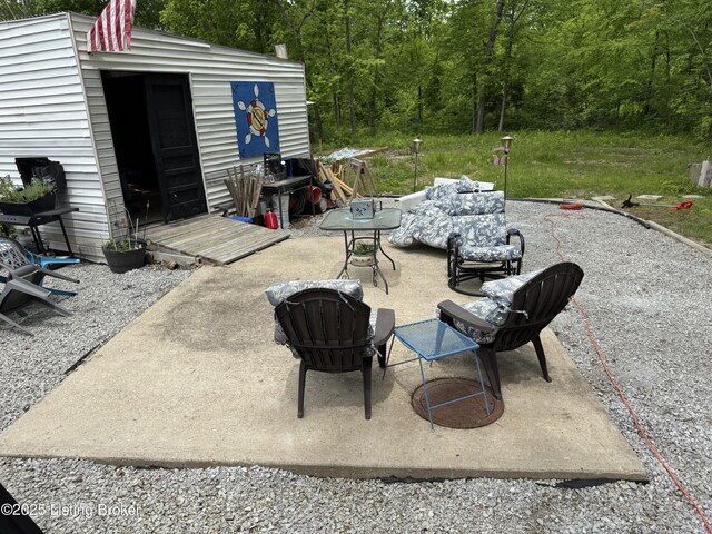 3031 Beech Grove Rd, Lebanon Junction, KY 40150 - view of patio / terrace featuring an outbuilding and a wooded view