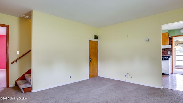 4011 Crawford Ave, Louisville, KY 40218 - carpeted empty room featuring stairs and baseboards