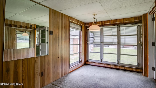 4011 Crawford Ave, Louisville, KY 40218 - carpeted empty room featuring wooden walls and a paneled ceiling
