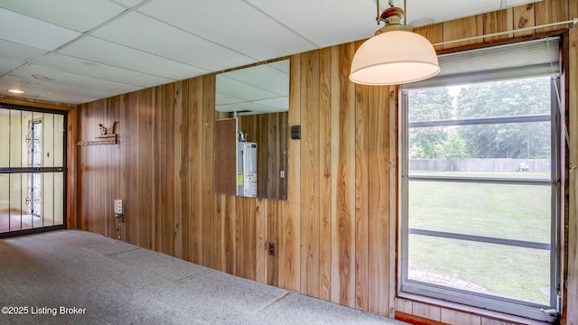 4011 Crawford Ave, Louisville, KY 40218 - dining space with wooden walls, gas water heater, and carpet