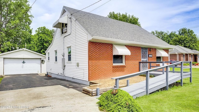 4011 Crawford Ave, Louisville, KY 40218 - view of property exterior featuring brick siding, a detached garage, an outbuilding, roof with shingles, and a yard