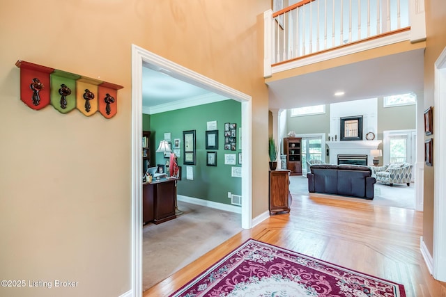 6516 Norman Ct, Crestwood, KY 40014 - foyer featuring a high ceiling, baseboards, a glass covered fireplace, ornamental molding, and wood finished floors